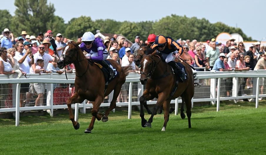 Crowds cheer on horseracing at Great Yarmouth Racecourse