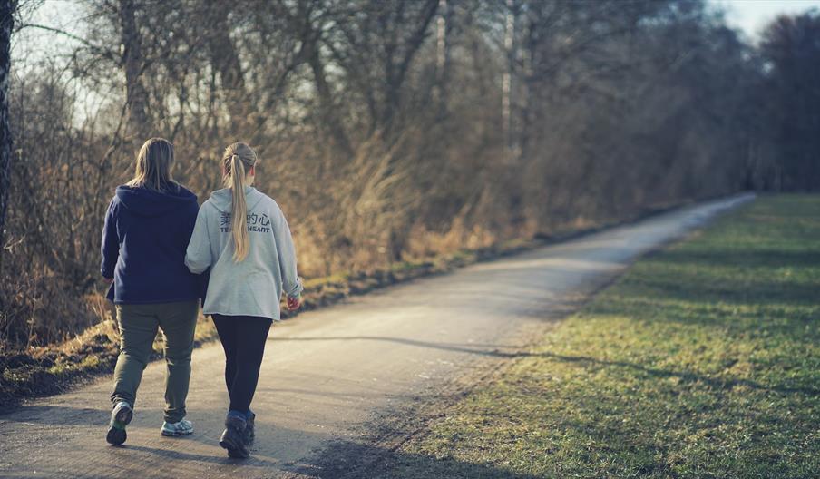 Two women walking along lane