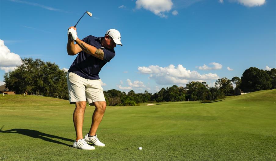 Golfer hitting ball