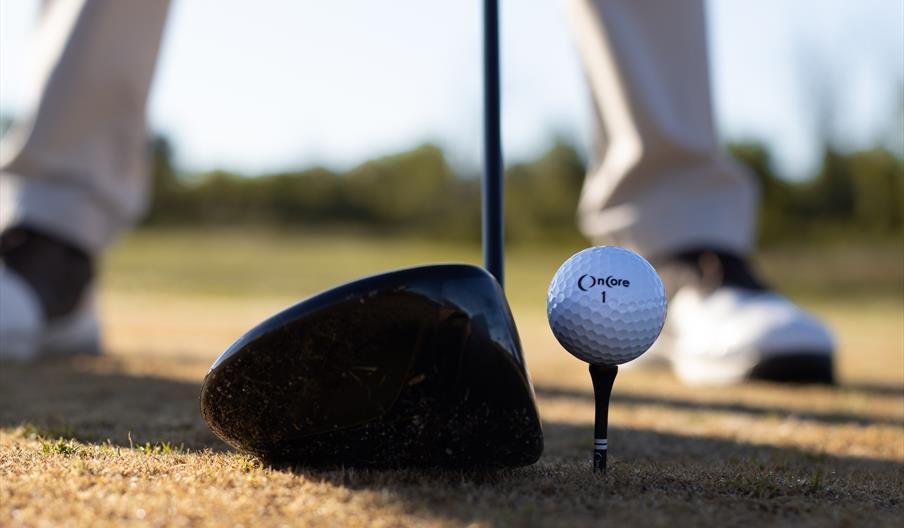 Golf club and ball on tee