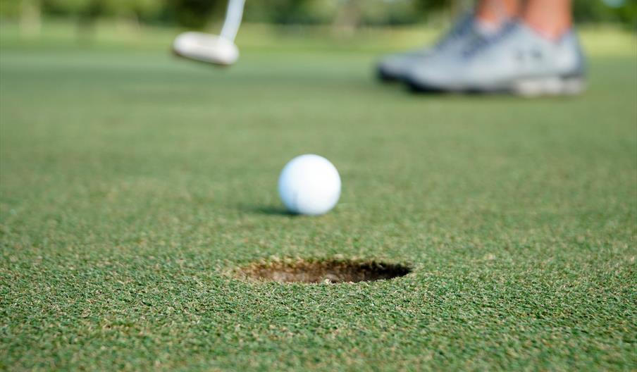 Golf ball being putted
