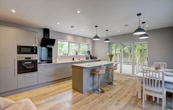 Open plan kitchen with dining table and island