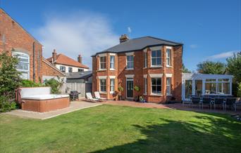 Hot tub outside with seating area and conservatory.  BBq and seating supplied