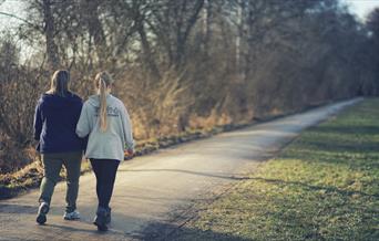 Two women walking along lane