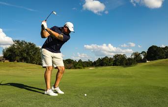 Golfer hitting ball