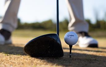 Golf club and ball on tee