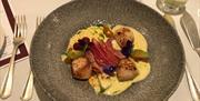 Scallop starter served in Cafe Cru Restaurant