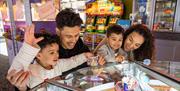 Family playing the Tupenny pushers at Richardson's Family Entertainment Centre