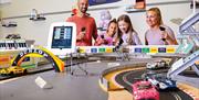 A family plays Scalextric at Potters Resorts Hopton-on-Sea