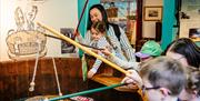 Young visitors play a game, with toy fishing rods and catching cardboard cut outs which include fish, seagulls and plastic bottles