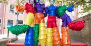 Freshly Greated - Rainbow Stilt Walkers